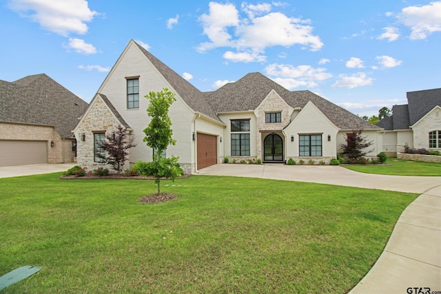 3116 Forest Ridge Cv, Tyler, TX 75703 - french country style house with driveway, stone siding, a front yard, an attached garage, and a shingled roof