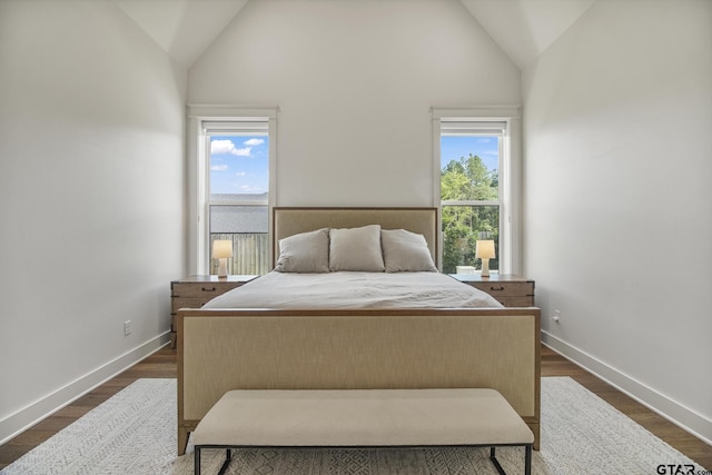 3116 Forest Ridge Cv, Tyler, TX 75703 - bedroom featuring multiple windows, baseboards, high vaulted ceiling, and dark wood-style floors