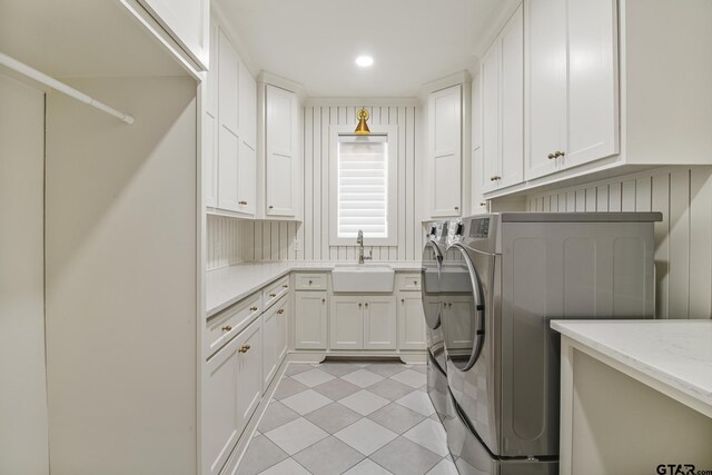 3116 Forest Ridge Cv, Tyler, TX 75703 - laundry area with washer and clothes dryer, cabinet space, light tile patterned floors, and recessed lighting