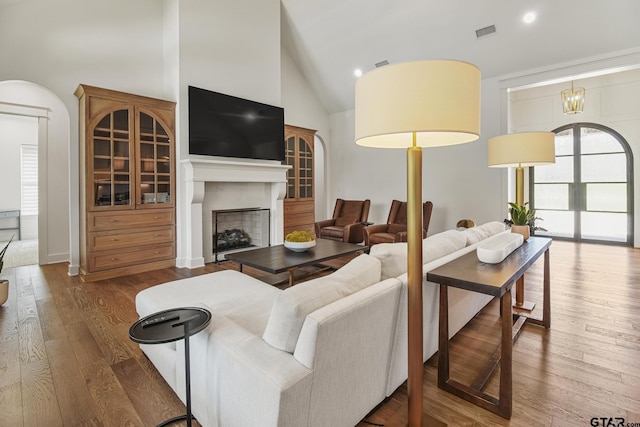 3116 Forest Ridge Cv, Tyler, TX 75703 - living room with wood finished floors, a fireplace, recessed lighting, and high vaulted ceiling