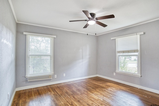 unfurnished room with a wealth of natural light, wood-type flooring, and crown molding