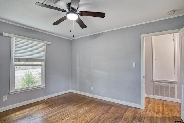 unfurnished room with hardwood / wood-style floors, ceiling fan, and crown molding