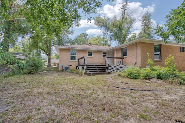 rear view of house featuring central AC