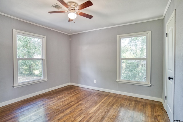 spare room featuring hardwood / wood-style flooring, ornamental molding, a healthy amount of sunlight, and ceiling fan