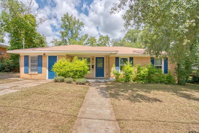 ranch-style home with a porch and a front lawn