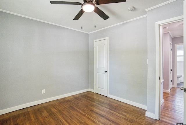 spare room with dark hardwood / wood-style flooring, ceiling fan, and crown molding