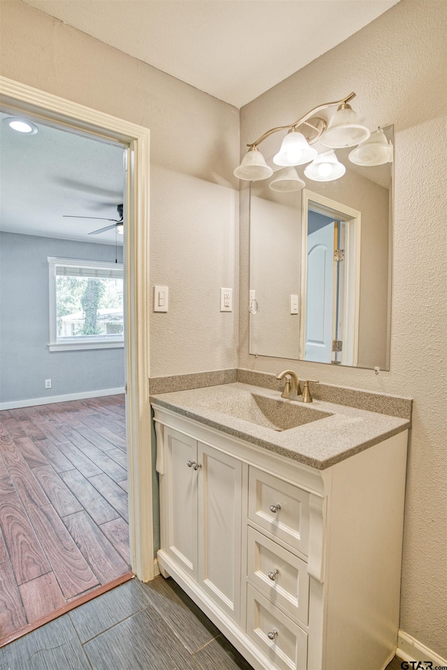 bathroom featuring hardwood / wood-style floors, ceiling fan, and vanity