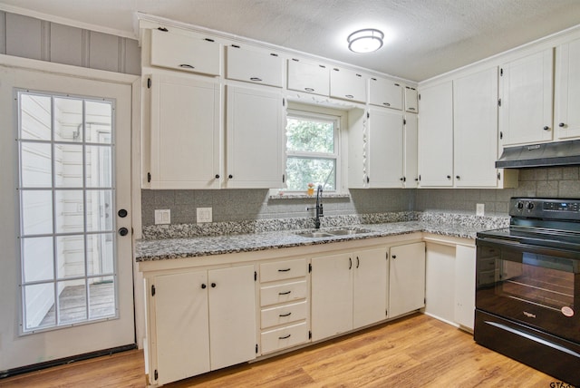 kitchen with white cabinets, light wood-type flooring, sink, and black range with electric stovetop