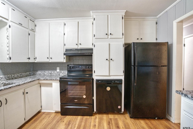 kitchen with black appliances, white cabinetry, light stone countertops, decorative backsplash, and light hardwood / wood-style flooring