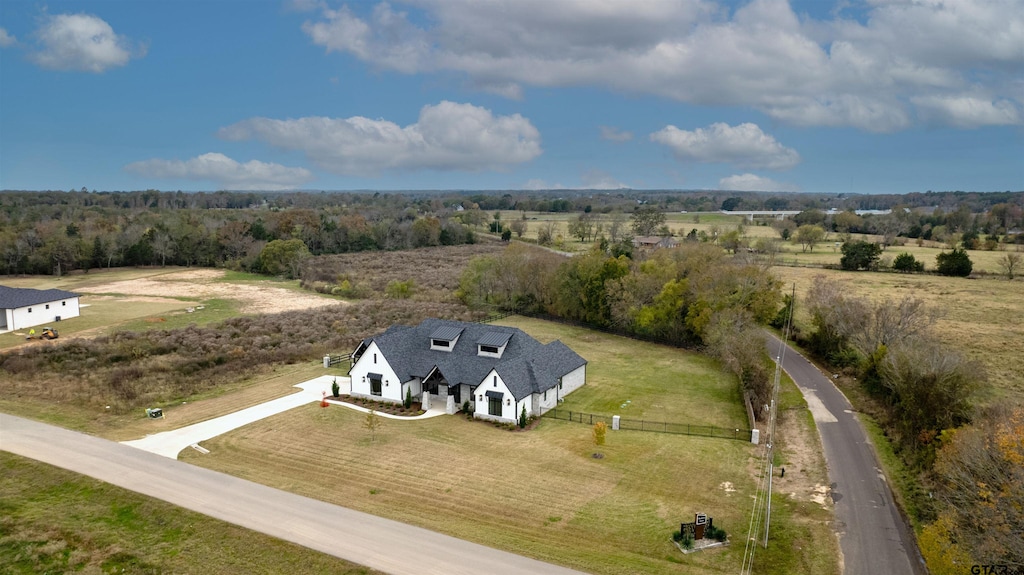 birds eye view of property with a rural view