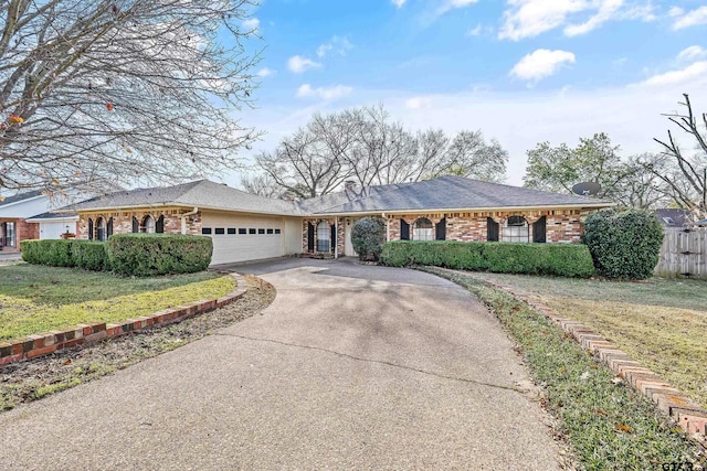 single story home with a garage and a front lawn