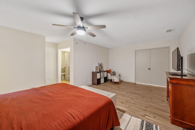 bedroom with ceiling fan, a closet, and light hardwood / wood-style flooring