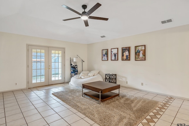 tiled living room with ceiling fan and french doors