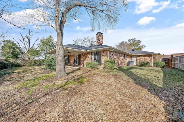 rear view of property featuring a lawn