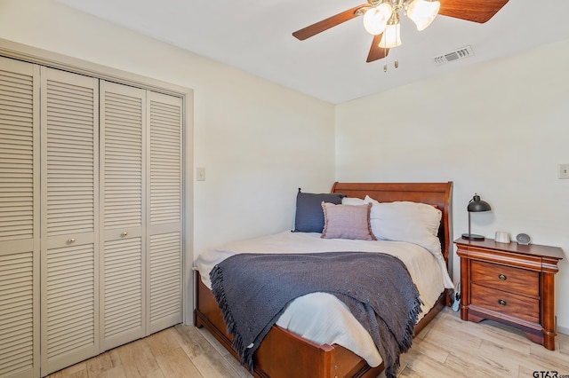 bedroom with ceiling fan, a closet, and light hardwood / wood-style floors