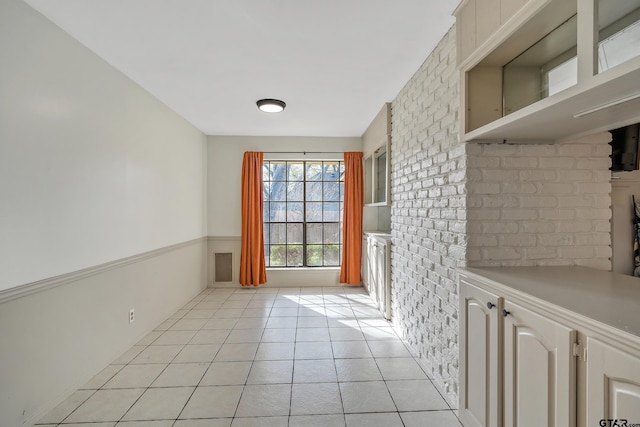 doorway to outside with light tile patterned floors