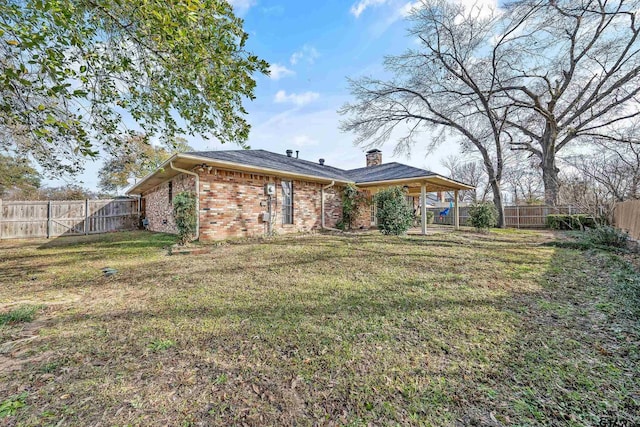 back of house with a lawn