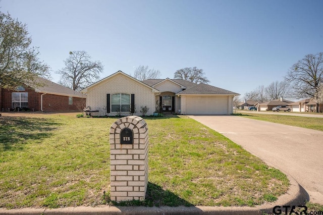 view of front facade featuring brick siding, driveway, a front lawn, and an attached garage