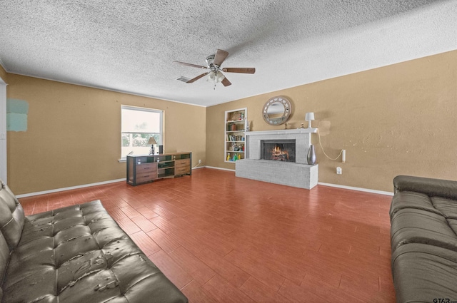 17607 Kristopher Cir, Whitehouse, TX 75791 - living area with a ceiling fan, a brick fireplace, a textured ceiling, built in features, and wood finished floors