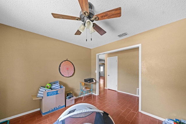 17607 Kristopher Cir, Whitehouse, TX 75791 - recreation room with wood finish floors, a ceiling fan, and a textured ceiling