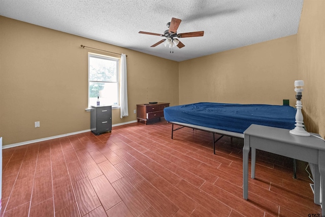 17607 Kristopher Cir, Whitehouse, TX 75791 - bedroom featuring wood finished floors, a textured ceiling, and ceiling fan
