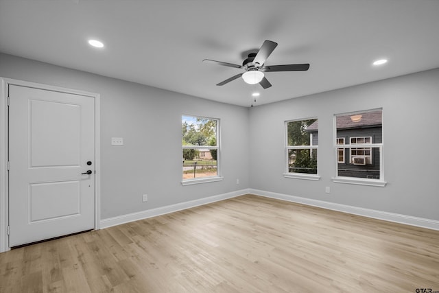 spare room with light wood-type flooring and ceiling fan