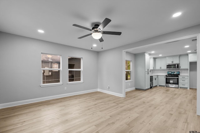 unfurnished living room with light hardwood / wood-style flooring and ceiling fan