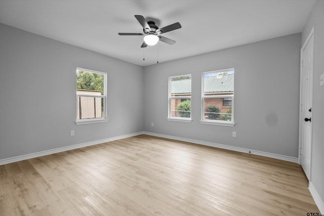 spare room featuring light wood-type flooring and a healthy amount of sunlight