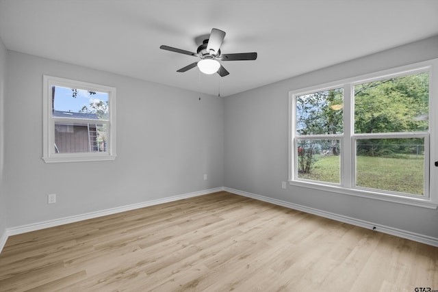 empty room with light hardwood / wood-style flooring and ceiling fan