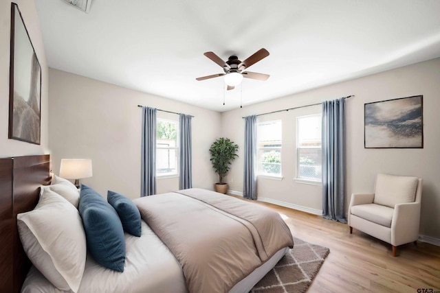 bedroom with light hardwood / wood-style flooring and ceiling fan