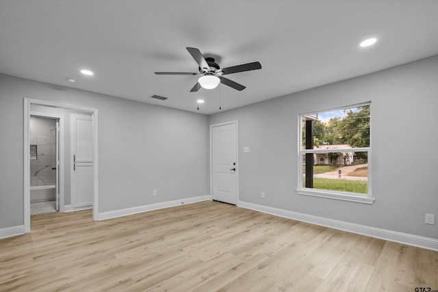 empty room with ceiling fan and light wood-type flooring