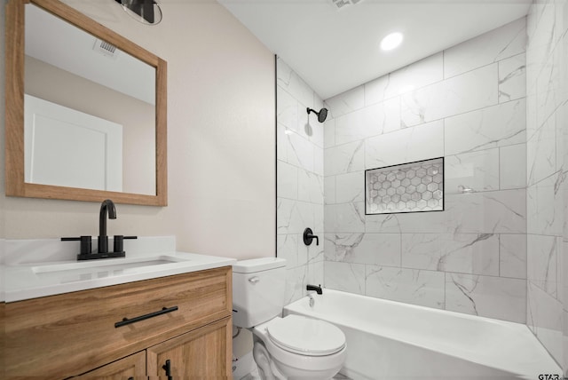 full bathroom featuring vanity, toilet, and tiled shower / bath