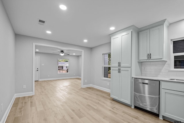 kitchen featuring stainless steel dishwasher, ceiling fan, light hardwood / wood-style floors, and tasteful backsplash