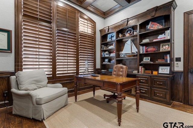 office area with coffered ceiling, wainscoting, wooden walls, and wood finished floors