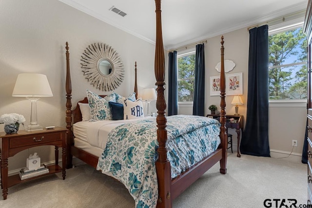 bedroom with baseboards, visible vents, crown molding, and carpet flooring