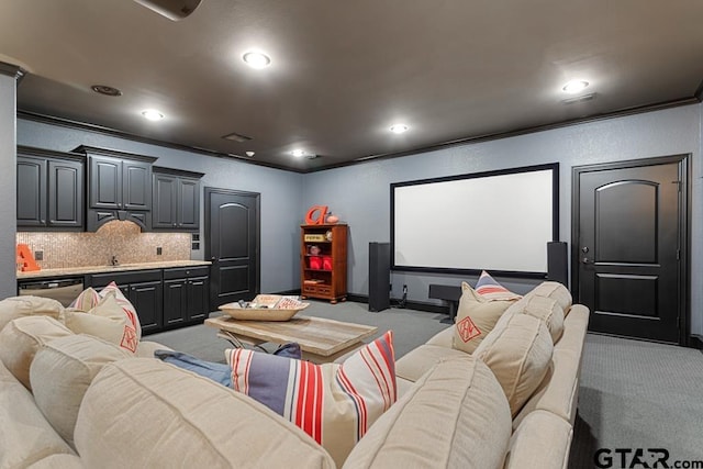 carpeted cinema with baseboards, crown molding, and recessed lighting