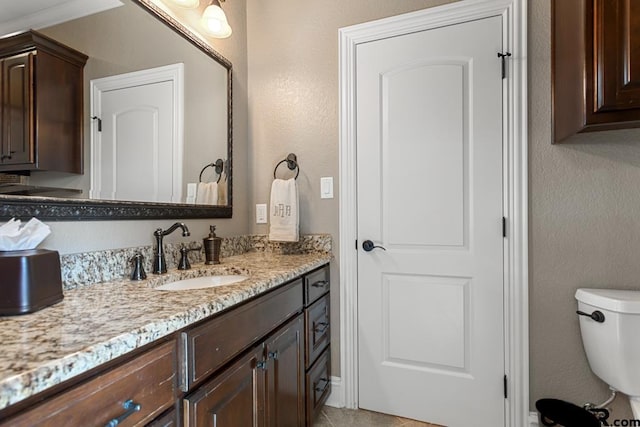 bathroom featuring toilet and vanity