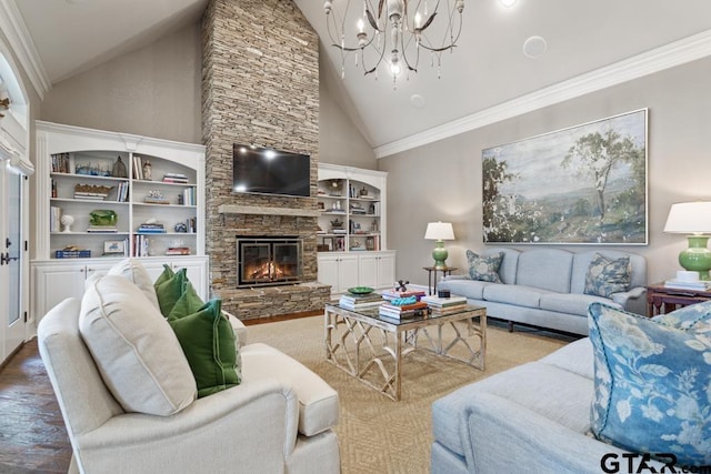 living room featuring high vaulted ceiling, ornamental molding, a stone fireplace, wood finished floors, and a chandelier