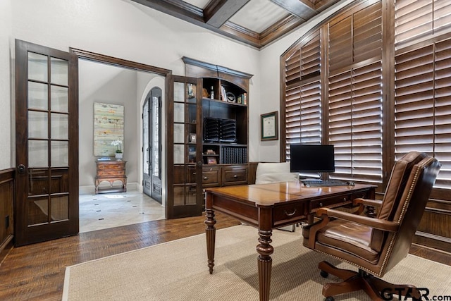 office space featuring ornamental molding, beam ceiling, coffered ceiling, and wood finished floors