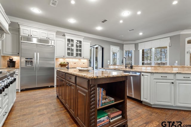 kitchen featuring appliances with stainless steel finishes, visible vents, crown molding, and white cabinetry