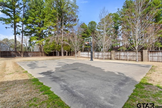 view of sport court with fence and basketball hoop