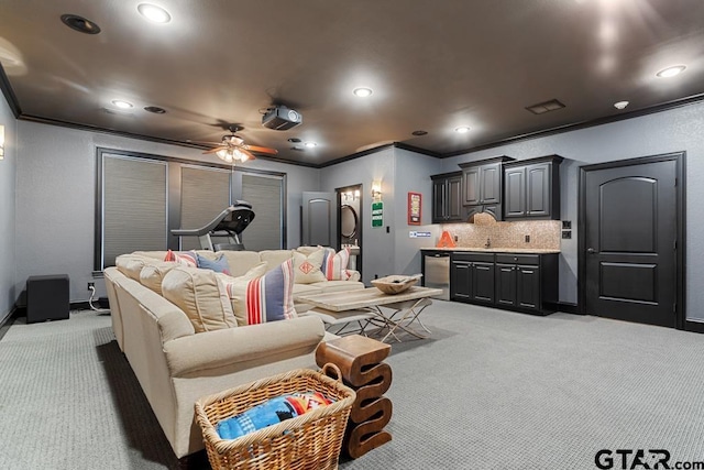 cinema featuring ceiling fan, ornamental molding, carpet, and recessed lighting