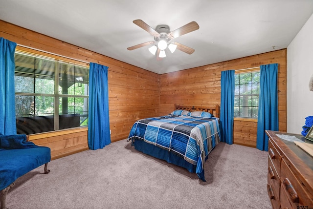 225 Springwood Cir, Chandler, TX 75758 - bedroom featuring wooden walls, carpet flooring, and ceiling fan