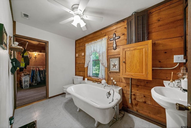 225 Springwood Cir, Chandler, TX 75758 - bathroom featuring wood walls, a freestanding tub, and ceiling fan