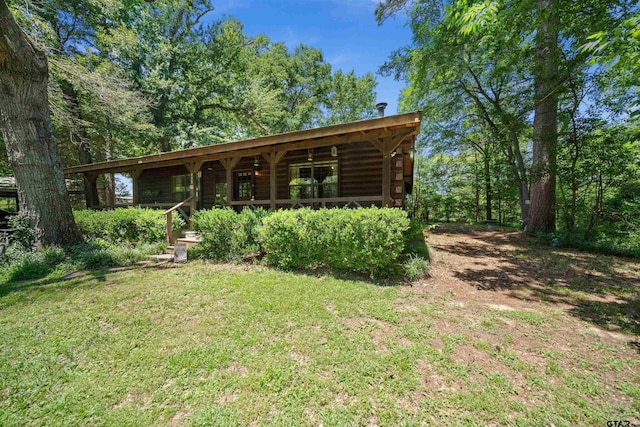 225 Springwood Cir, Chandler, TX 75758 - back of house featuring a yard and a porch