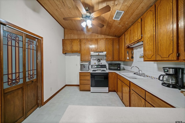 225 Springwood Cir, Chandler, TX 75758 - kitchen featuring electric range oven, under cabinet range hood, brown cabinets, light floors, and vaulted ceiling