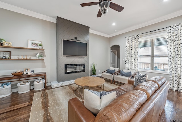 204 Providence Pl, Bullard, TX 75757 - living room with arched walkways, dark wood finished floors, a ceiling fan, ornamental molding, and a large fireplace