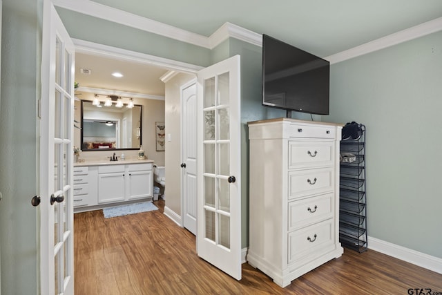 5298 Leaning Oaks Dr, Flint, TX 75762 - bathroom featuring ornamental molding, wood finished floors, vanity, baseboards, and french doors