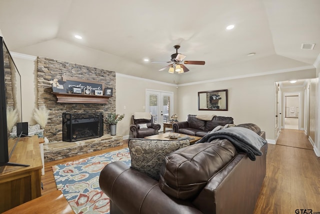 5298 Leaning Oaks Dr, Flint, TX 75762 - living room featuring wood finished floors, french doors, a ceiling fan, baseboards, and a stone fireplace