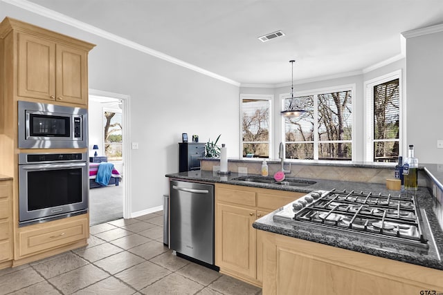 kitchen with stainless steel appliances, light brown cabinets, sink, crown molding, and pendant lighting